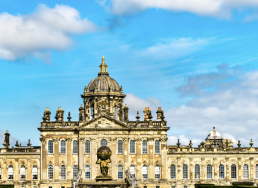 Historic stately home with ornate architecture and dome, set against a blue sky, representing attractions near York for visitors of Woodland Lakes Holiday Lodges.