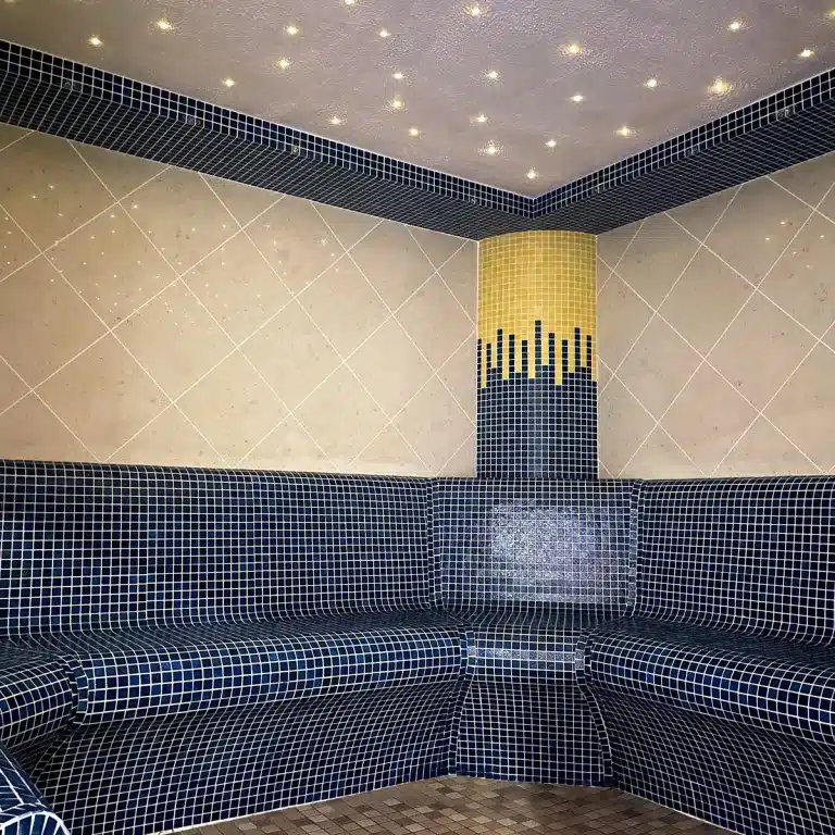 Aroma room with tiled seating and starry ceiling, part of the spa facilities at Woodland Lakes Holiday Lodges, promoting relaxation and wellness.